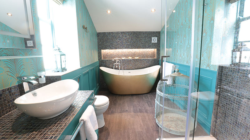 Peacock coloured mosaic tiled bathroom